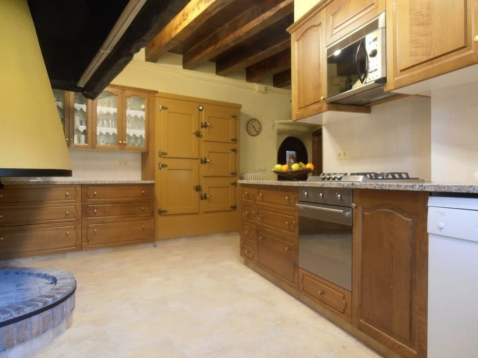 The large kitchen in main house includes fireplace & working old wooden fridge!
