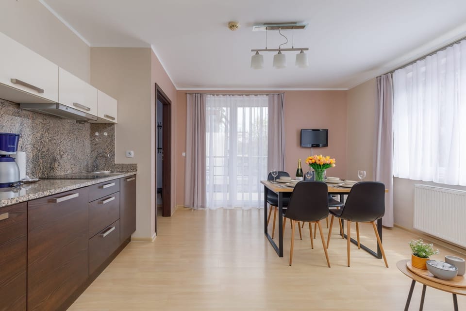Kitchenette with coffee machine and refrigerator. 