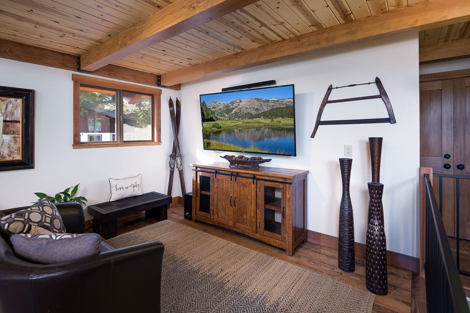 Another view of living area with flat screen TV to right of fireplace