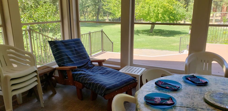 Relax on the screen porch beside the orchard...