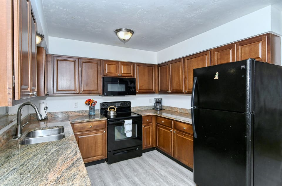 A function, easy to work kitchen with plenty of cabinets & storage.
