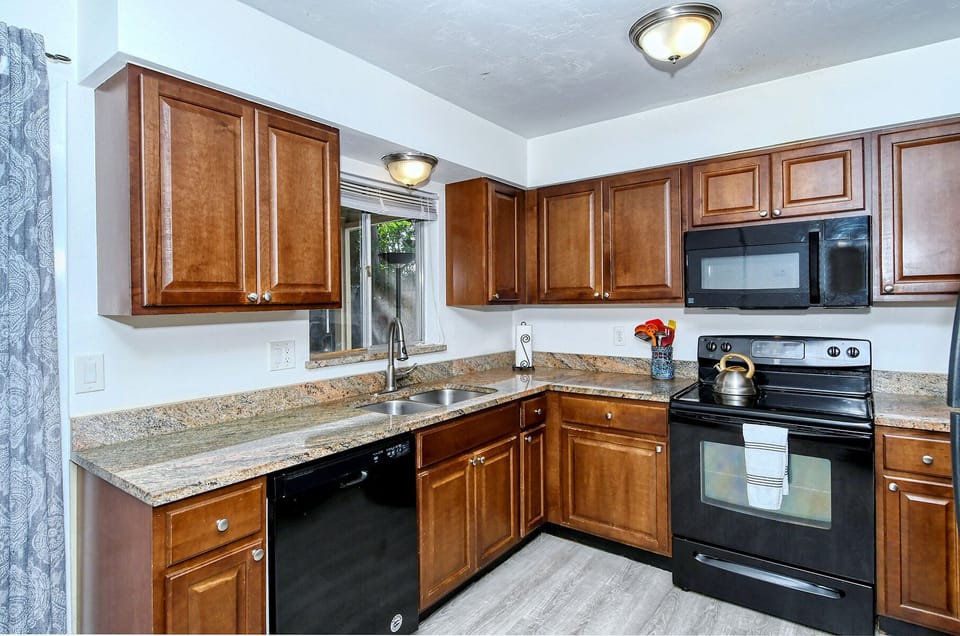 Kitchen with quality pots, pans, dishes, serving dishes, glasses & even spices. 
