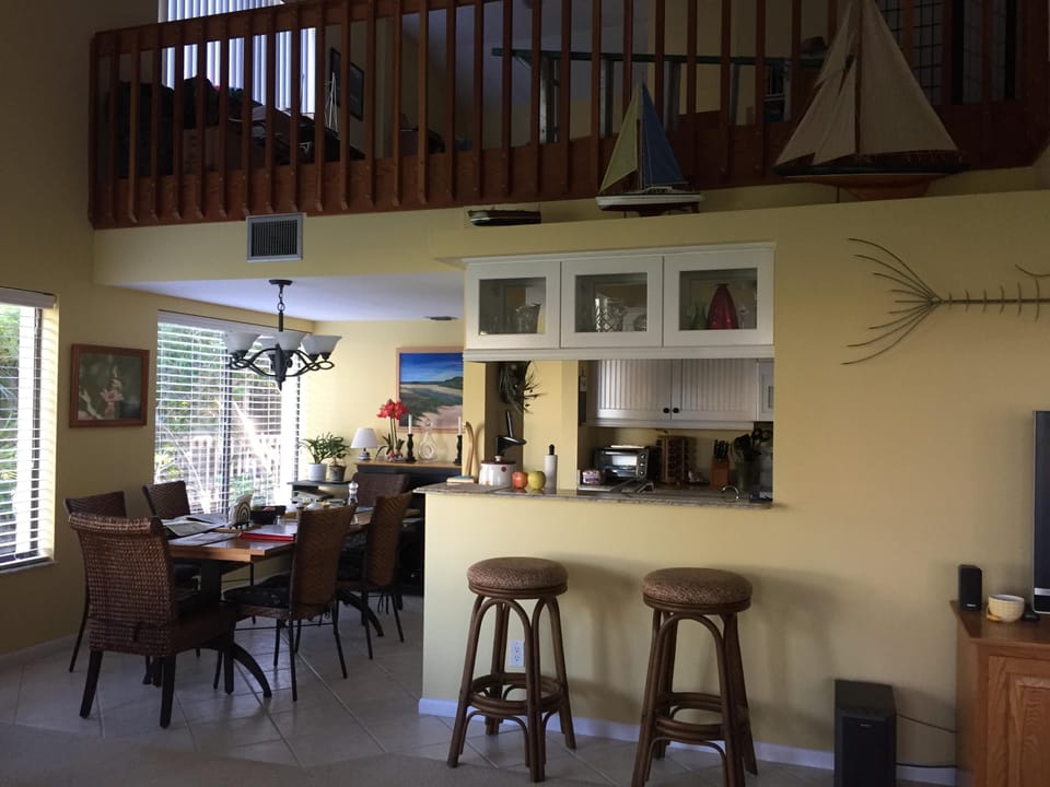 Living area with TV, stereo, couch, love seat coffee & end tables, swivel chairs