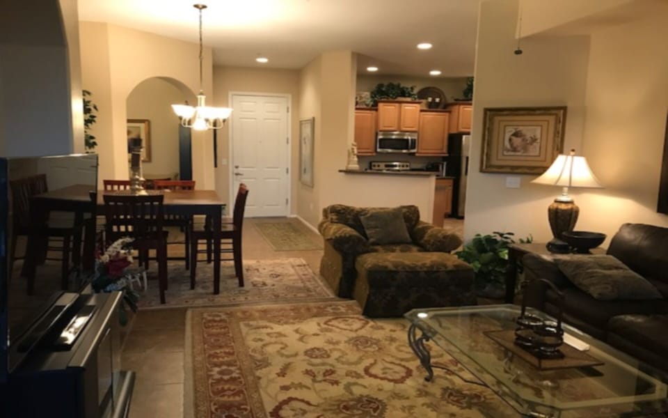Overview looking into living room, dining room, den and kitchen.