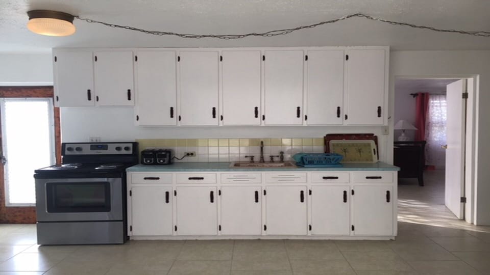 Spacious Kitchen, Stainless Steel Appliances, and an Array of Organized Utensils