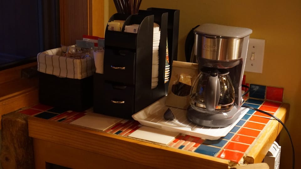 Coffee pot, coffee, sugar/creamers, snacks and small fridge provided.