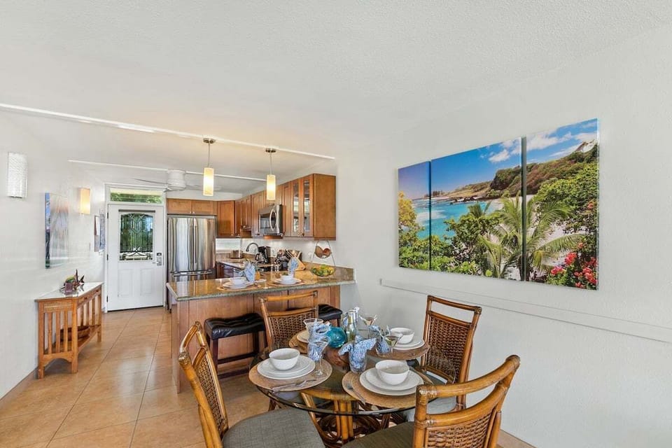 Open dining space with rattan seating, garden‑view windows, and easy flow into the living and kitchen areas for group meals.