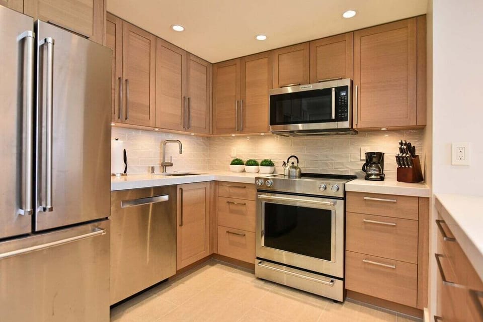 Bright and well-appointed kitchen with a refrigerator, stove, microwave, and dishwasher, making meal prep and cleanup a breeze