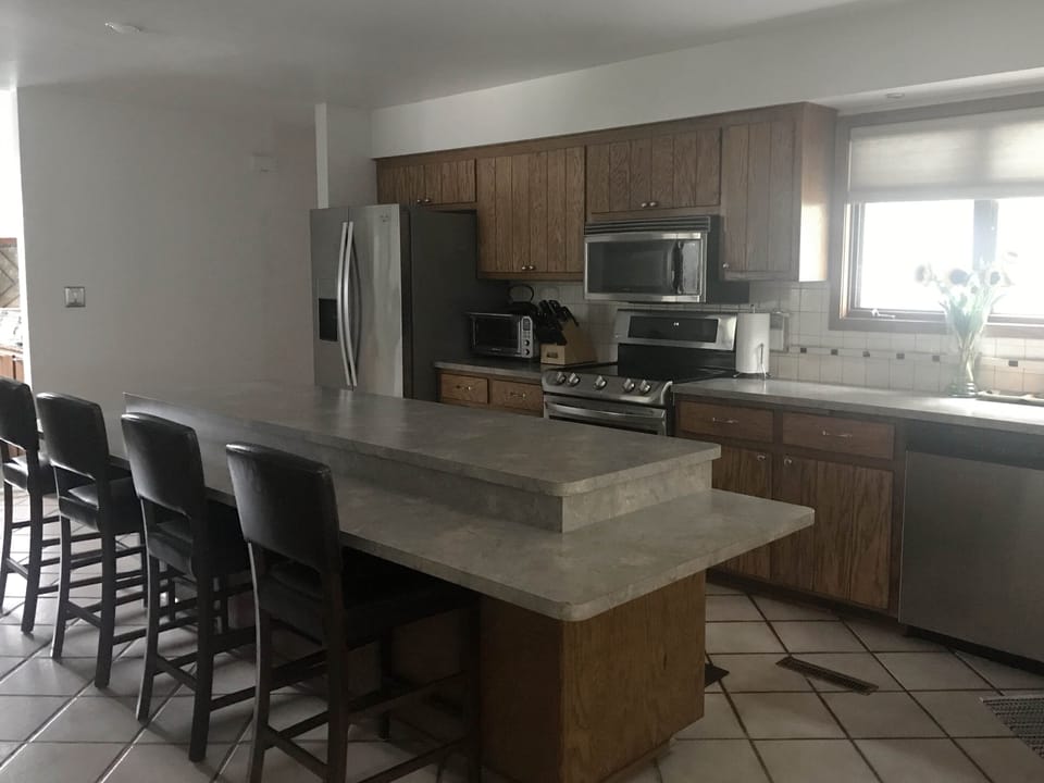 Fully stocked kitchen with large island and seating.