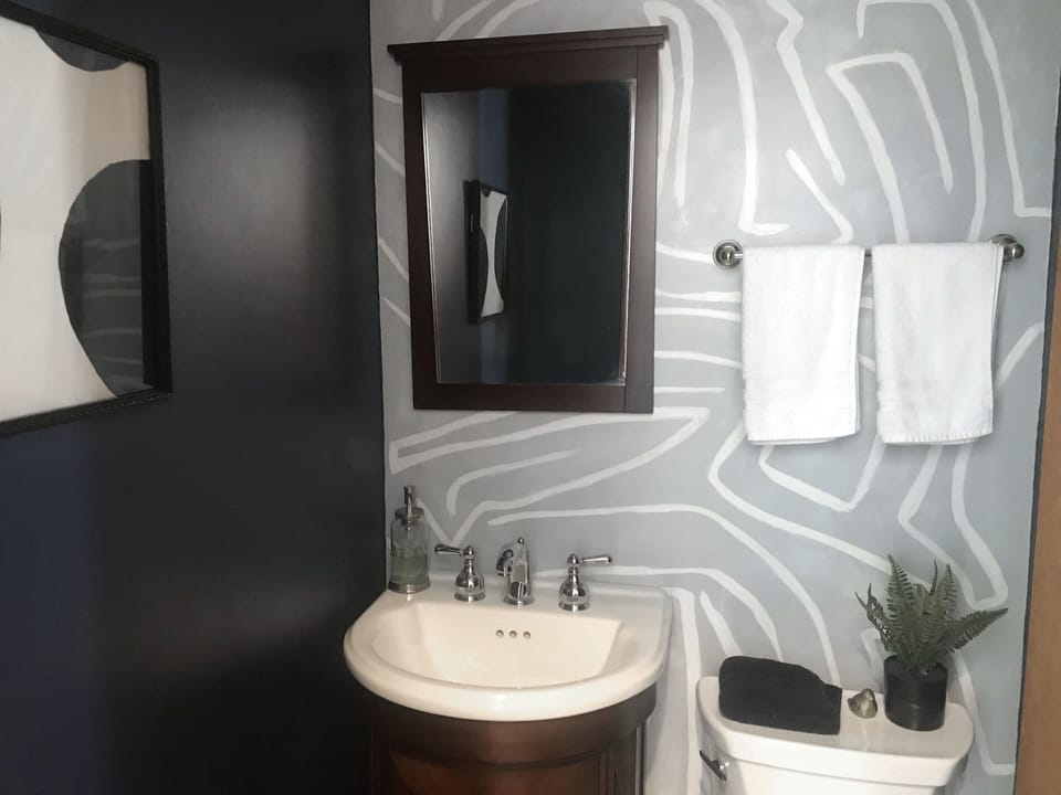 Half bath off entrance hallway, adjacent to kitchen and dining rooms.