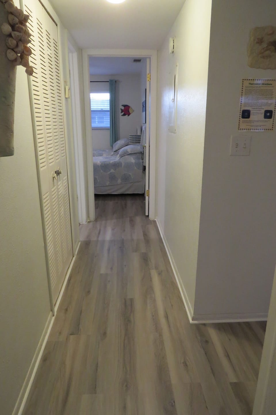 Hallway from primary bedroom to 2nd bedroom and bathroom