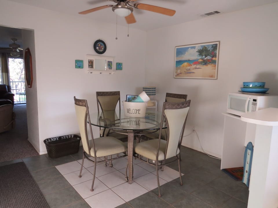 Dining area in kitchen with welcome bucket on the table.