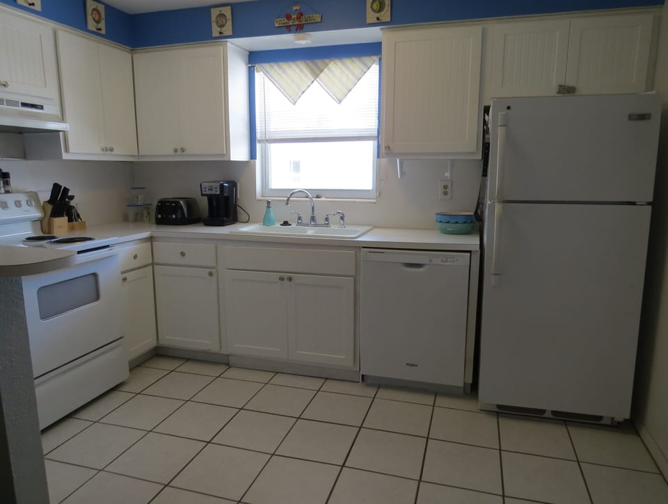 Fully stocked kitchen with all of the utensils, dishes, glasses, appliances...