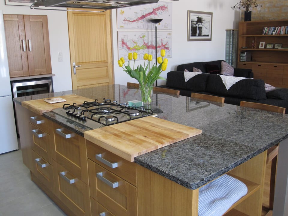 Beautiful, modern kitchen where the chef can join in the fun in the living area