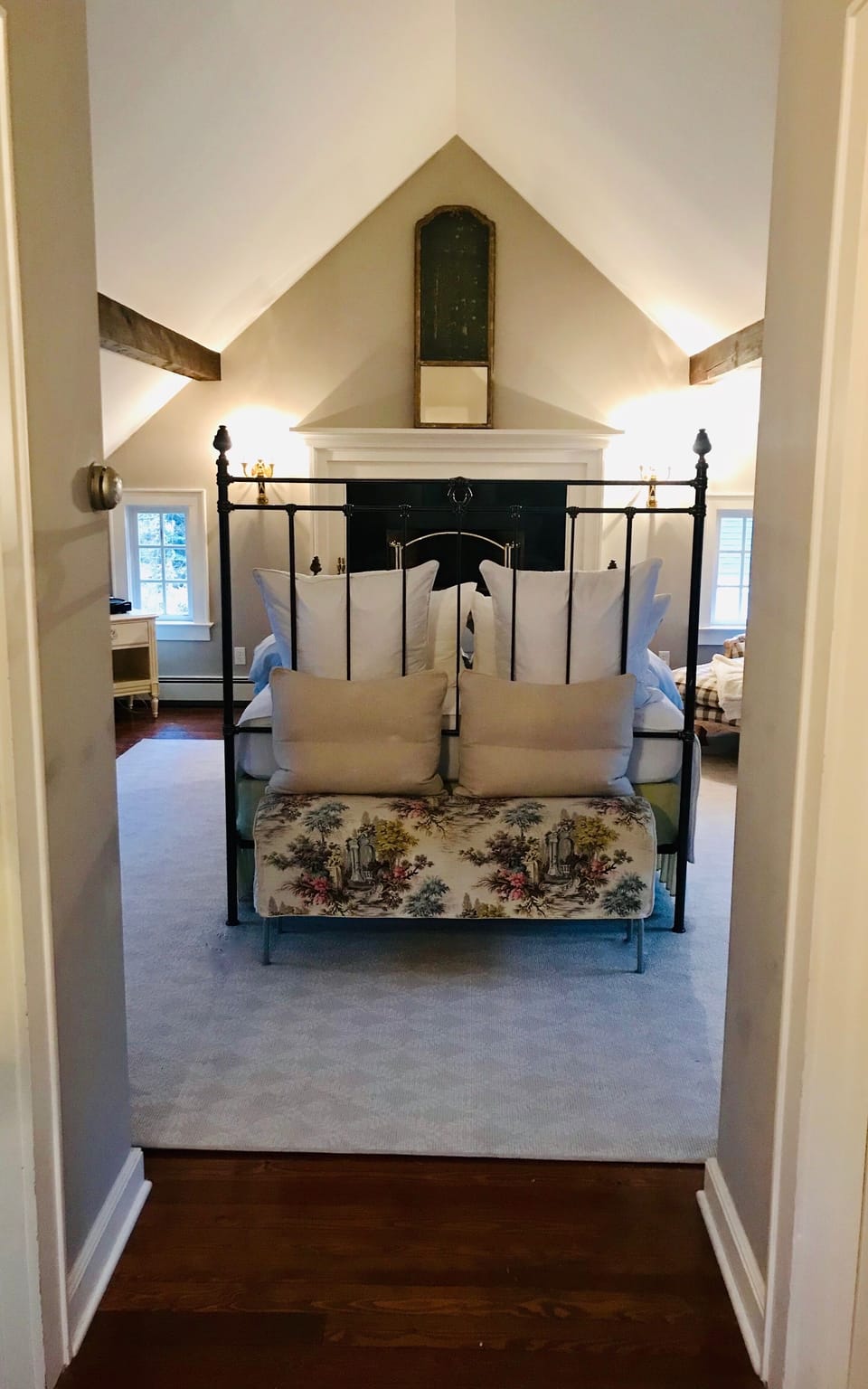 Bedroom suite 1 with queen bed and decorative fireplace