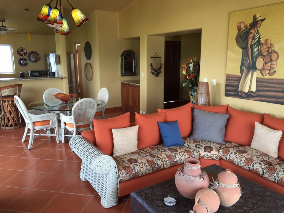 Large living, dining, kitchen area with Mexican tiled floors throughout
