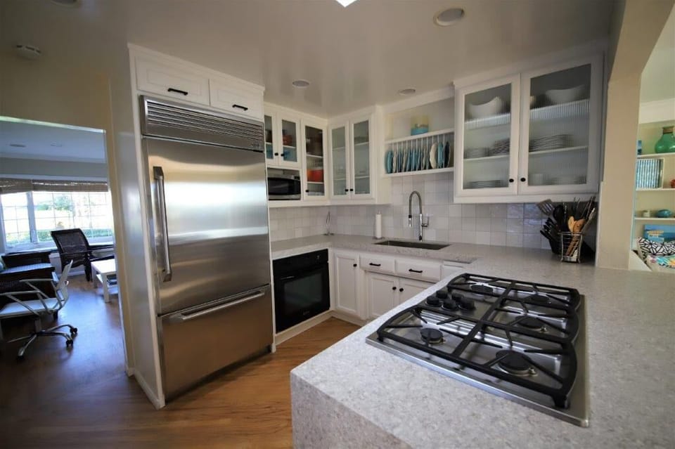 Large built-in Fridge, cabinets filled with cooking needs. New countertops