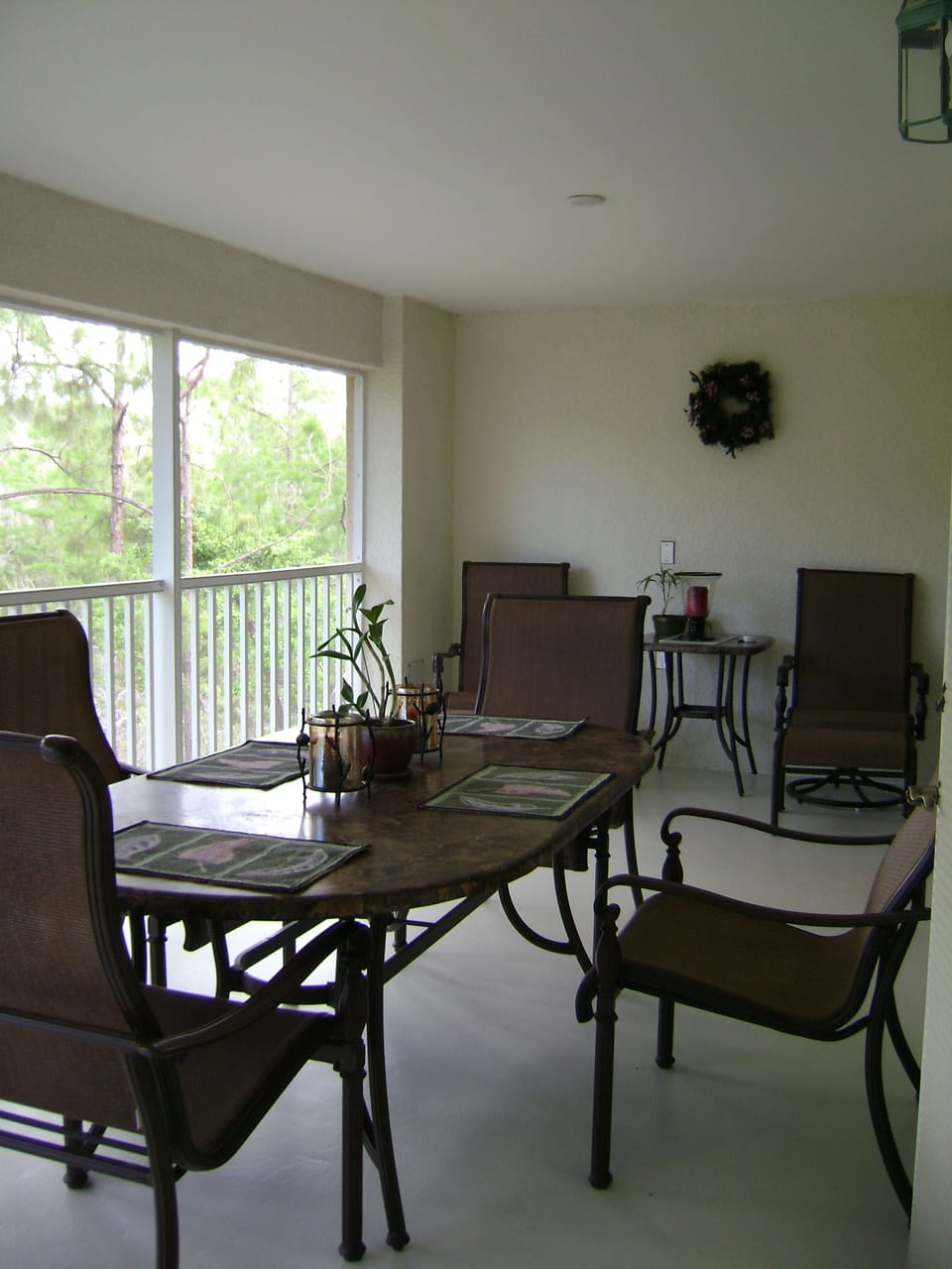 Lanai furniture features granite top and sling style high back seating.