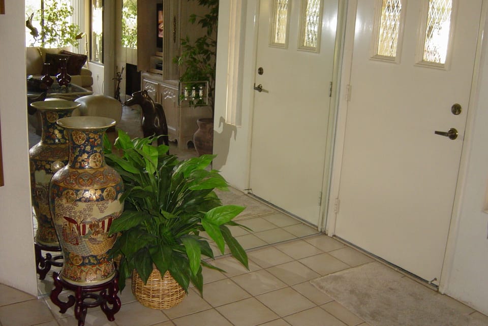 Here's a "genuine artificial "plant adjoining  our Oriental vase beside mirror. 