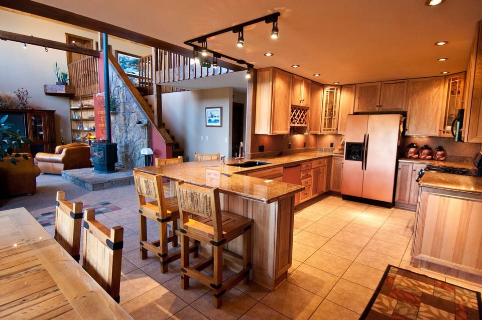 Copper fridge and dishwasher are a few of the accents in well stocked kitchen.
