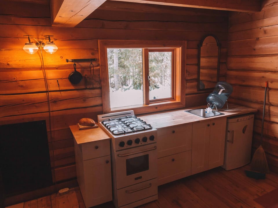 Kitchen with gas stove and fridge/freezer.
