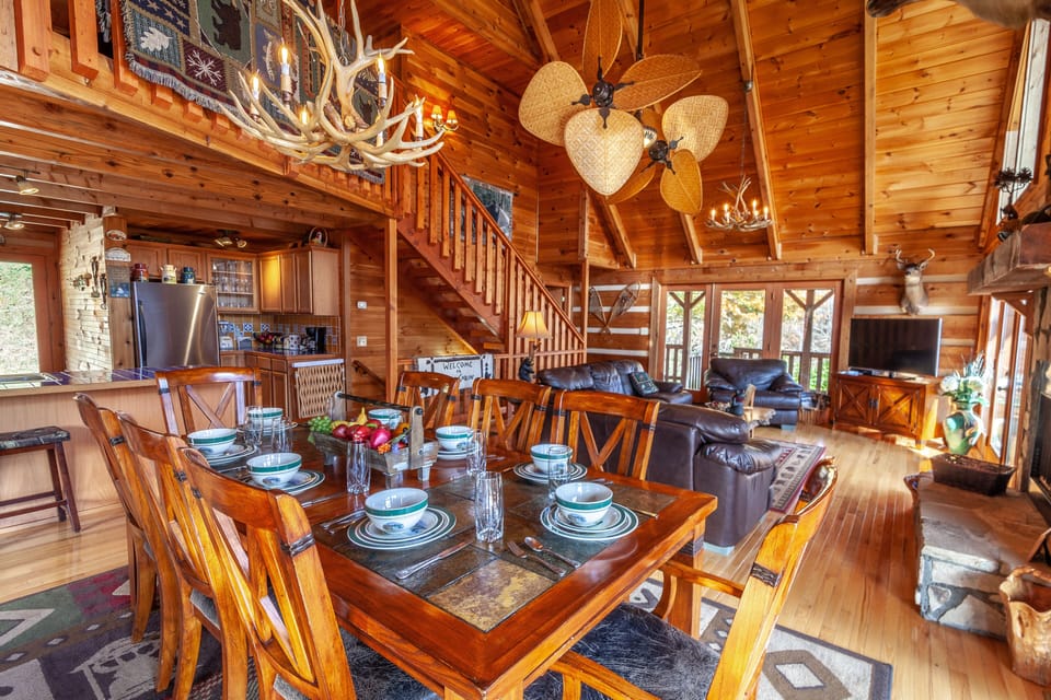 Main Level Living Area Boasts Hardwood Floors, Vaulted Ceilings, a Stone Fireplace, and Open Floor Plan