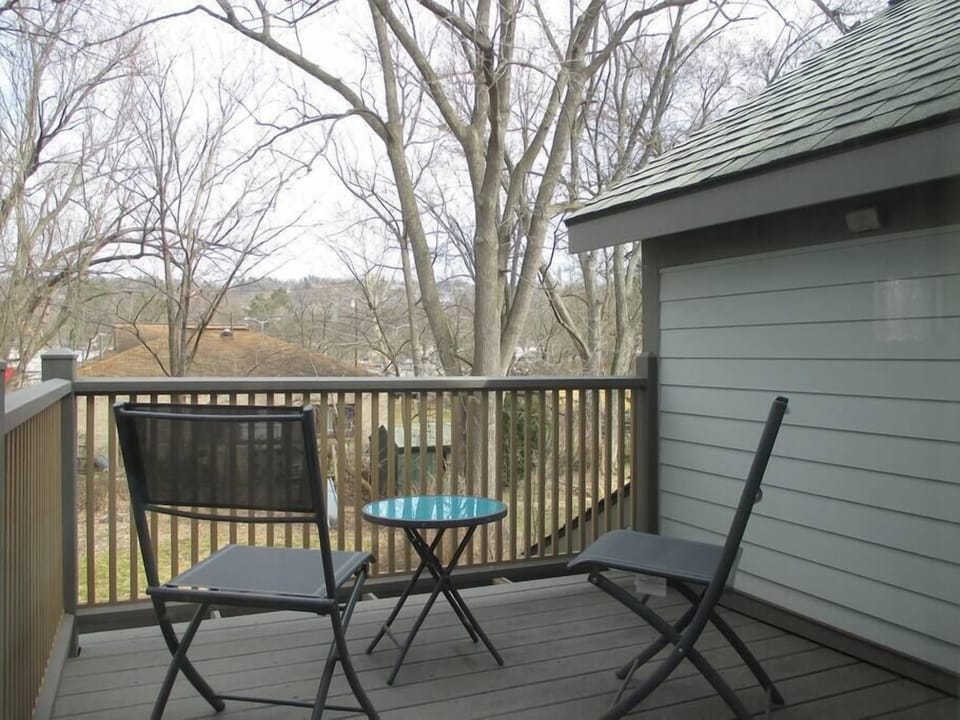 Porch with views of the back garden and swing set.