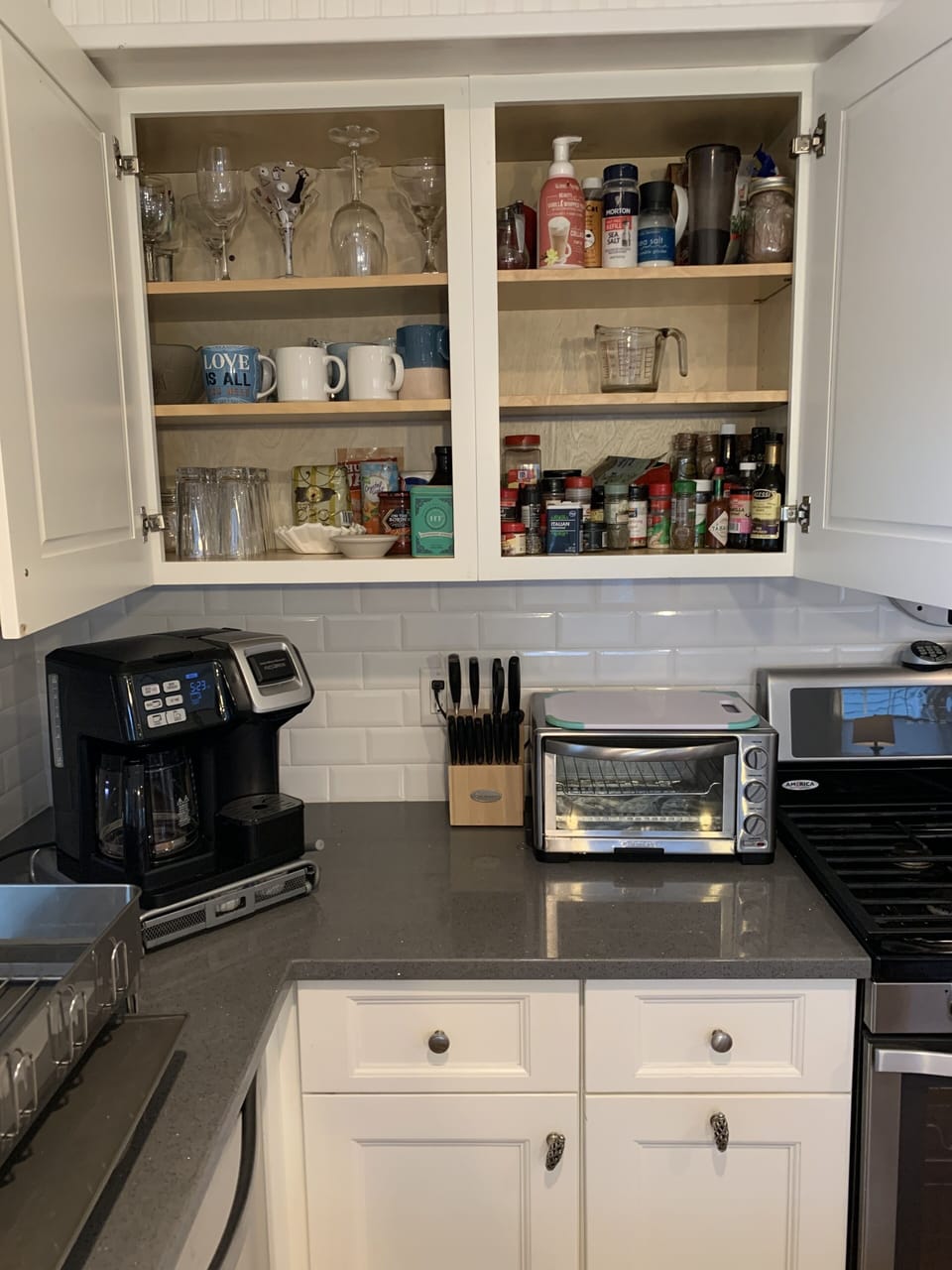 Kitchen cabinet is fully stocked with spices for cooking