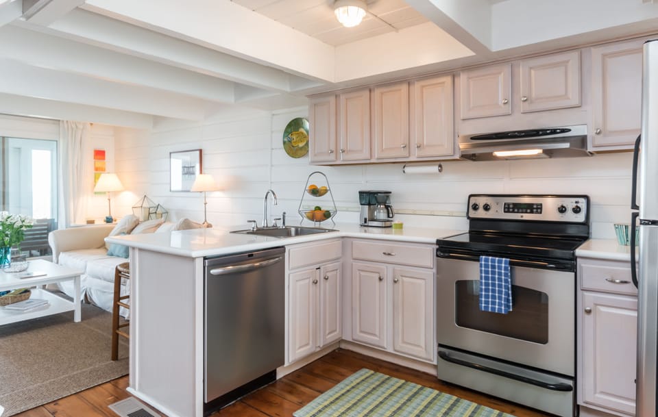 Kitchen with all the kitchen gadgets  you need.  Microwave, coffee grinder & pot