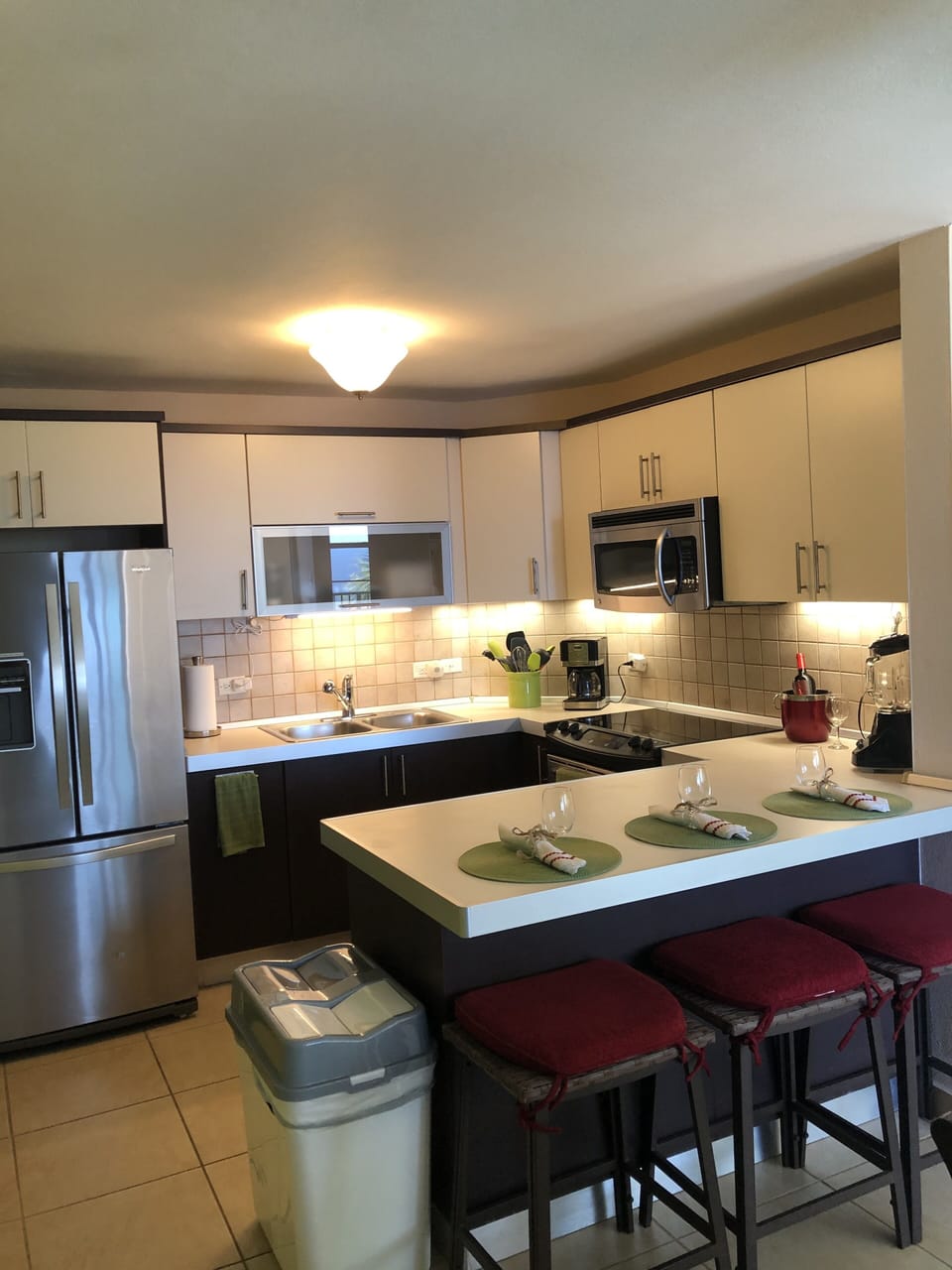 Fully Equipped Modern Kitchen with LED Undercabinet Lighting and Seating for 3