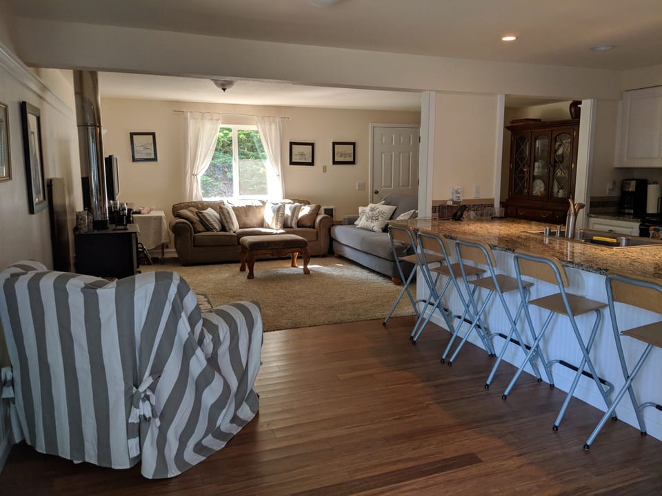 Open floor plan kitchen, dining bar and living room with fireplace