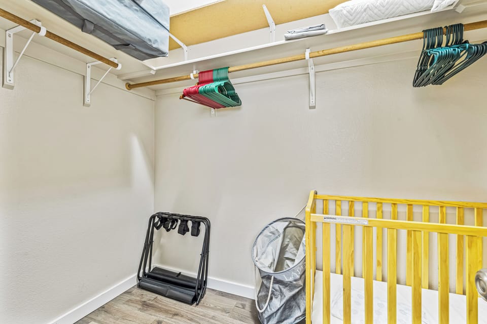 Crib available in a closet space for guests with infants
