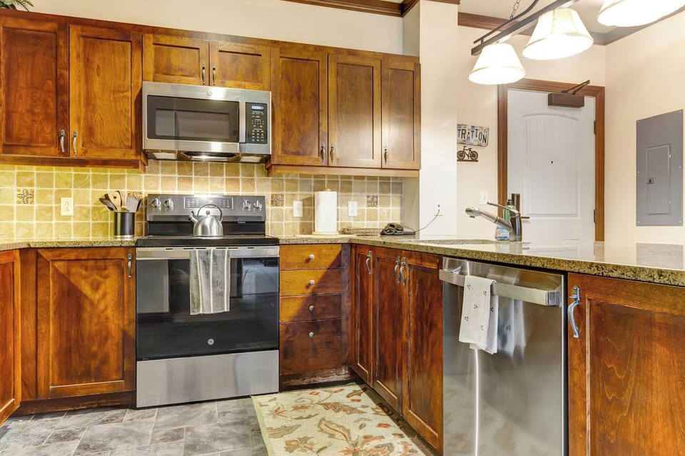 Updated kitchen featuring new stove and dishwasher appliances.
