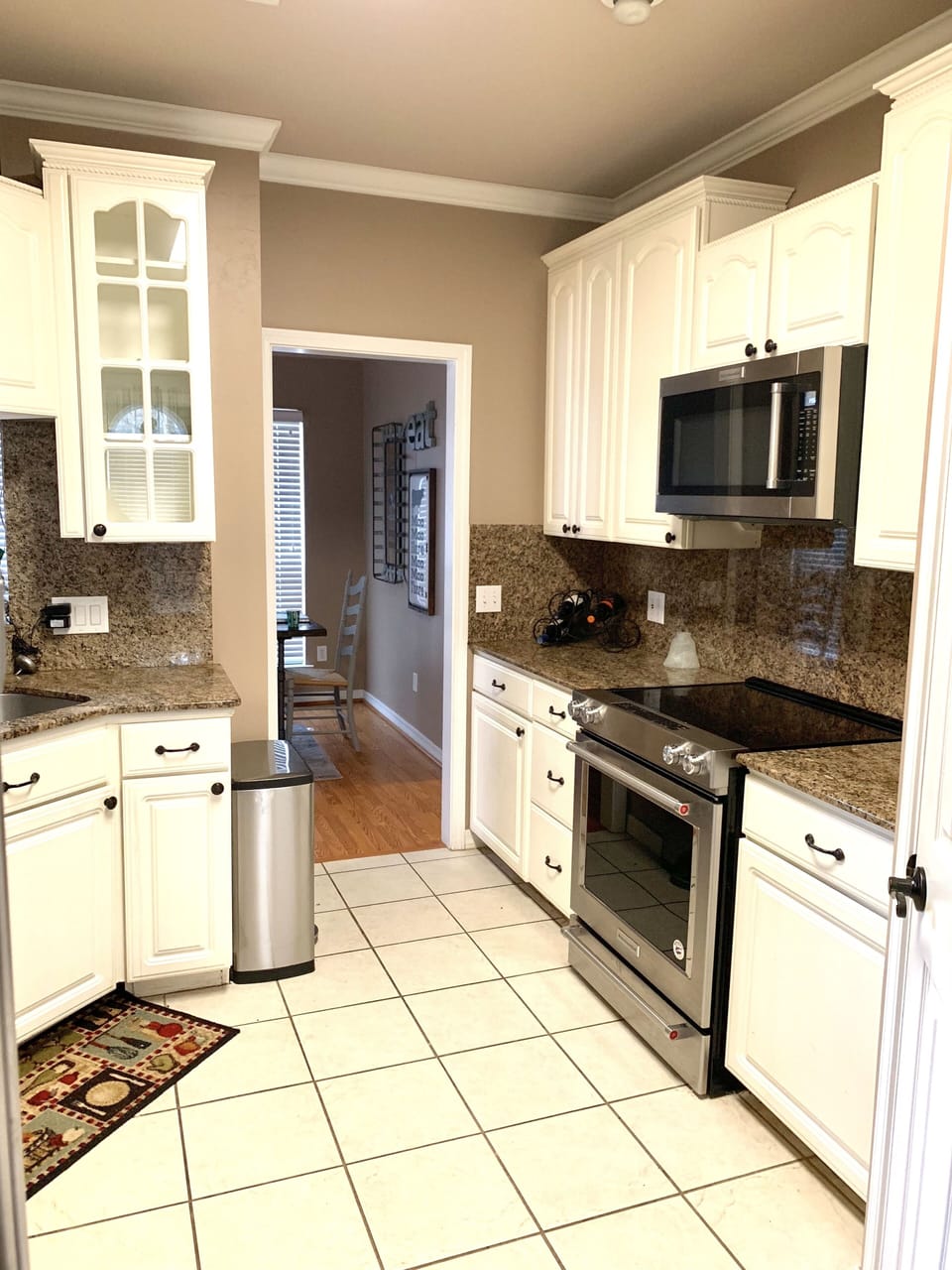 Fully stocked kitchen with pots, pans, dishes, and cookware. 