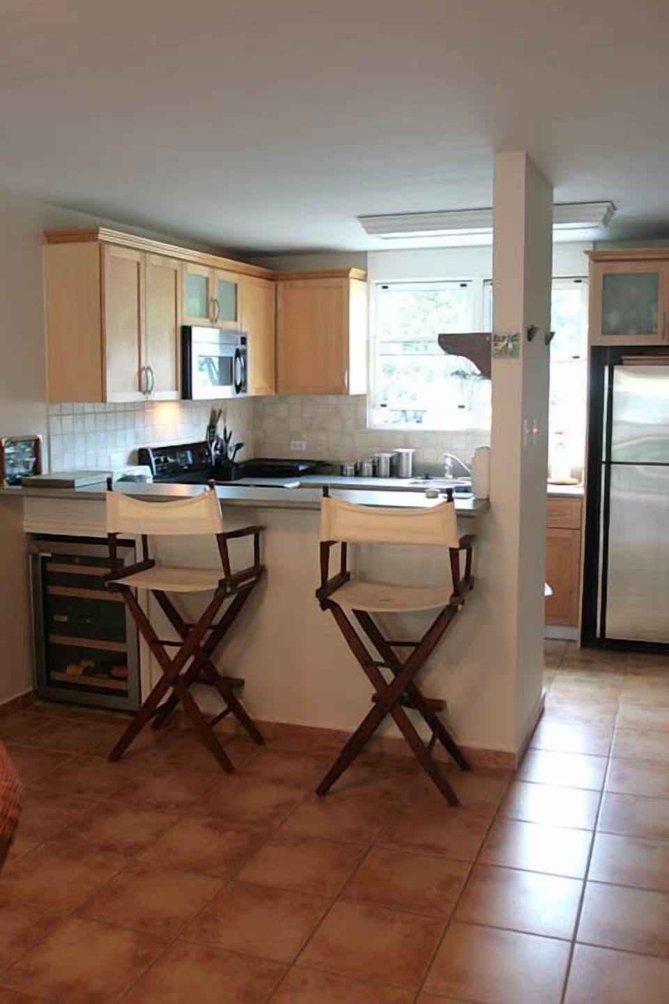 Full Kitchen with wine cooler, dishwasher, microwave, toaster oven