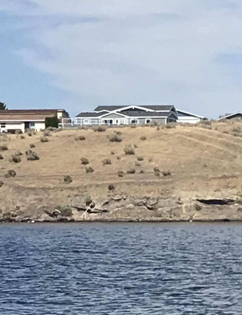 Sage House perched above the river