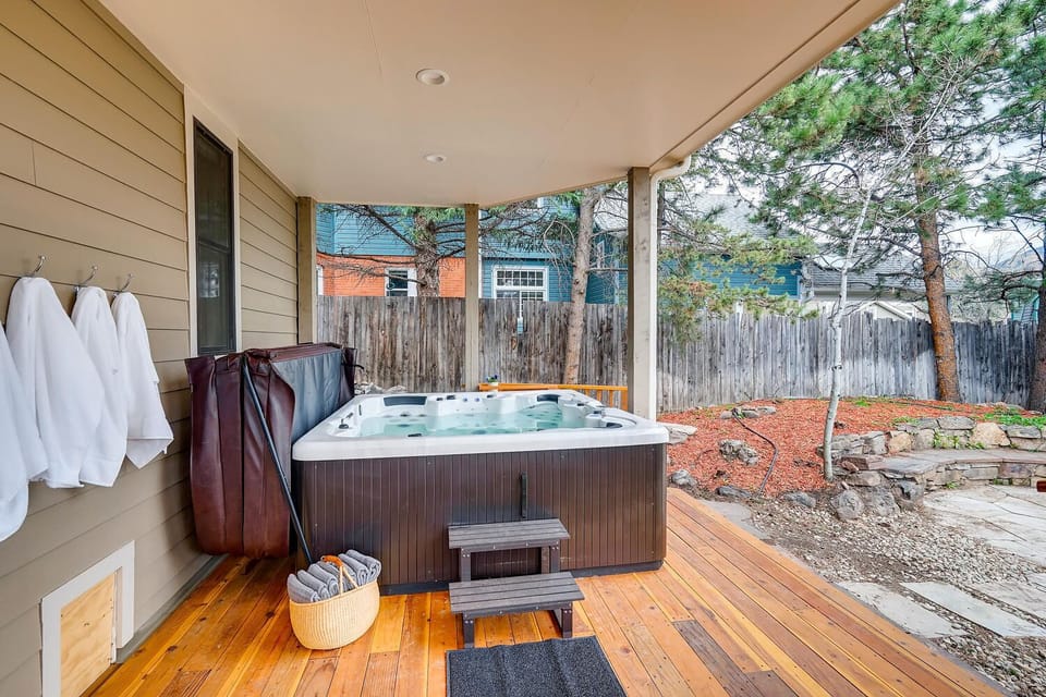 Large hot tub in serene back yard with mountain views.