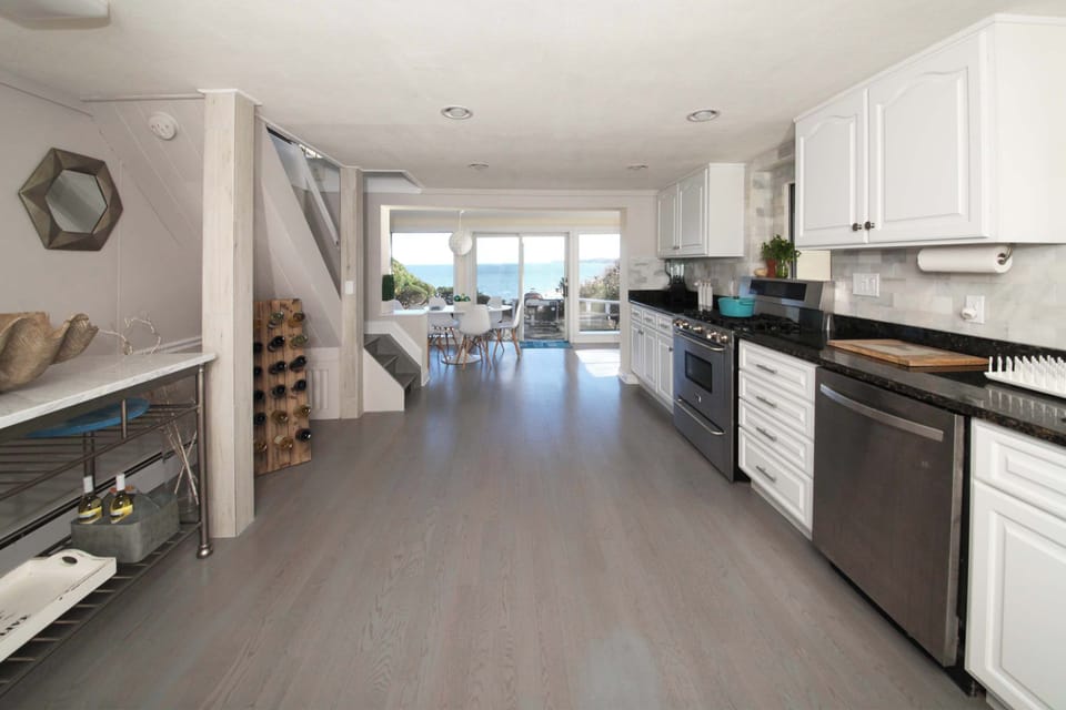 Kitchen with white shaker cabinetry and granite countertops