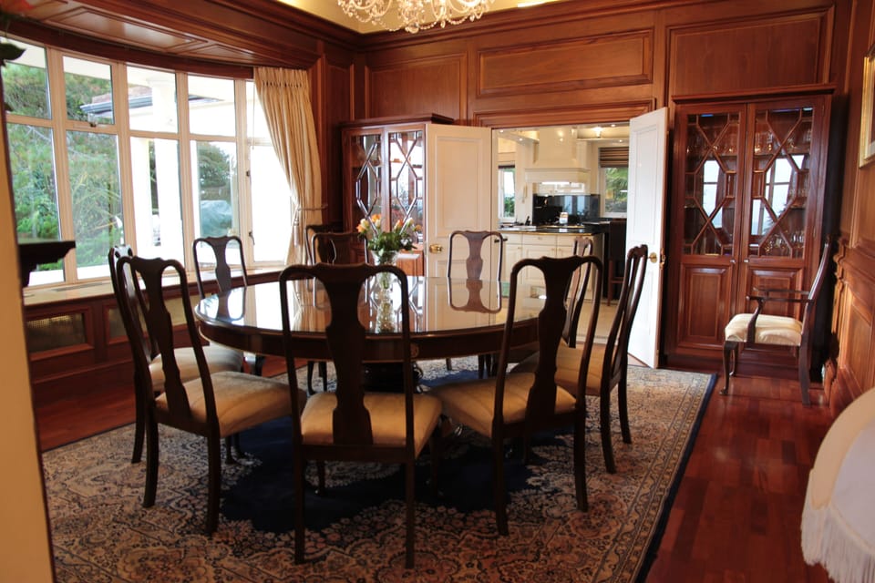 Wood paneled dining room with ocean view. Seating for 10-12 people.