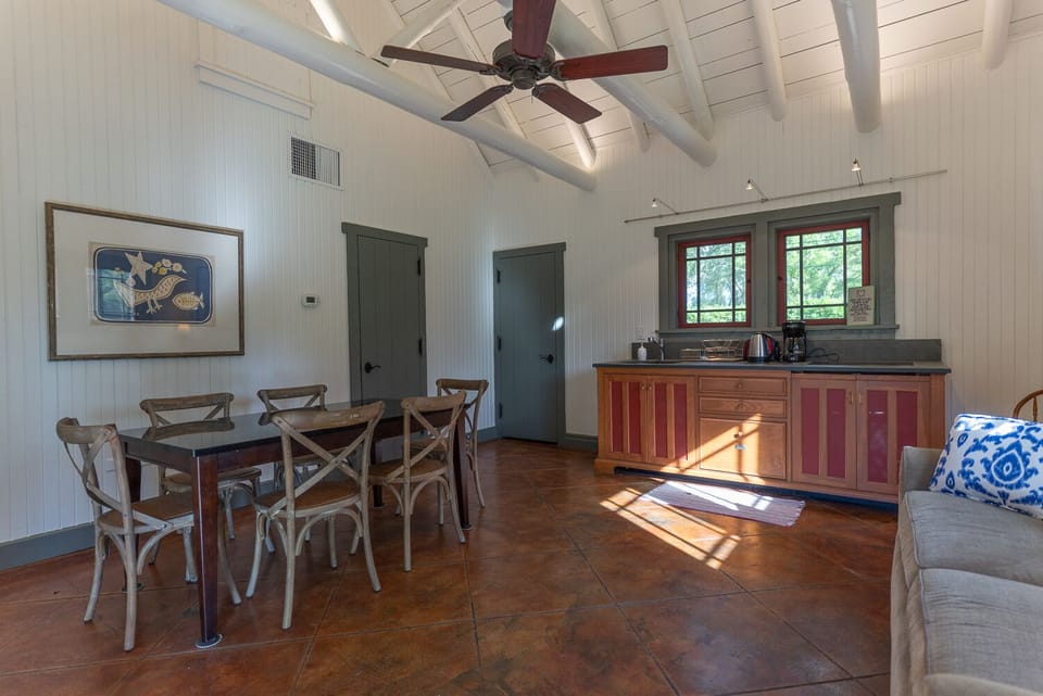 Dining table and kitchen unit. The fridge is in the pantry just behind the door.
