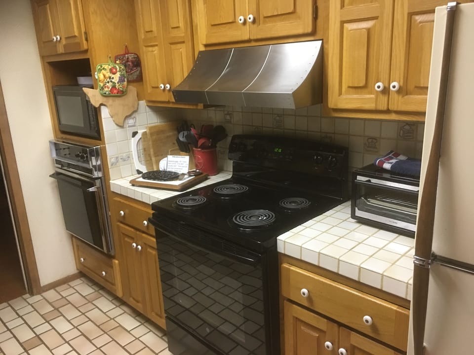 Stove area w/pots, pans, utensils, cutting boards, etc. for all your cooking