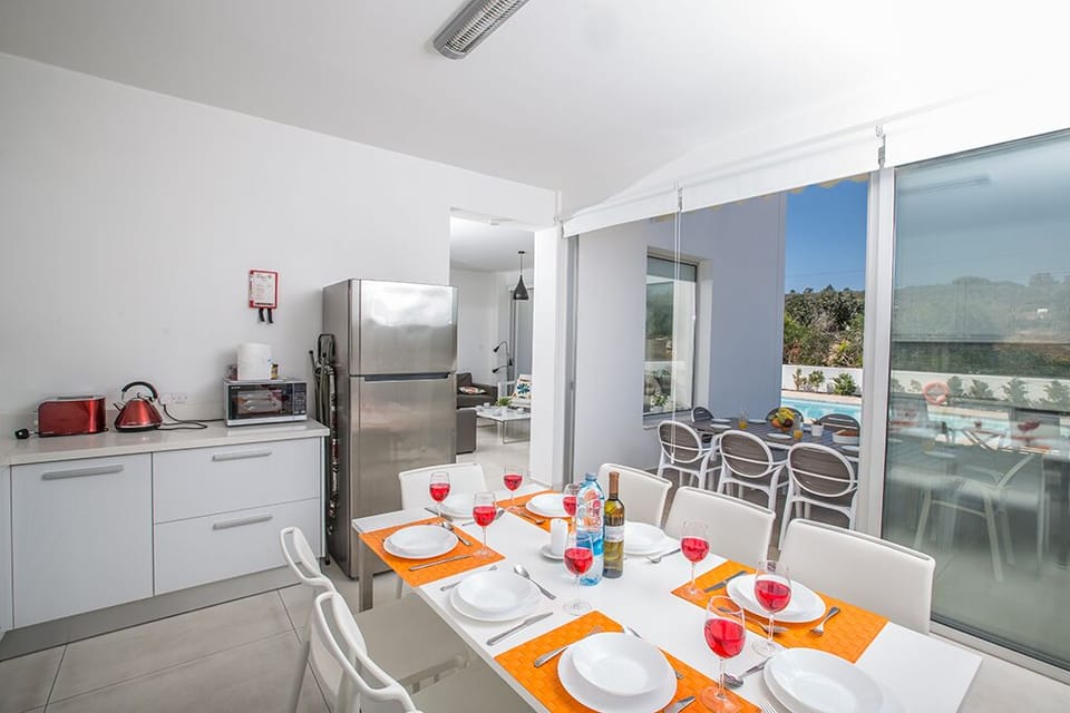 Dining area with patio doors leading to the pool