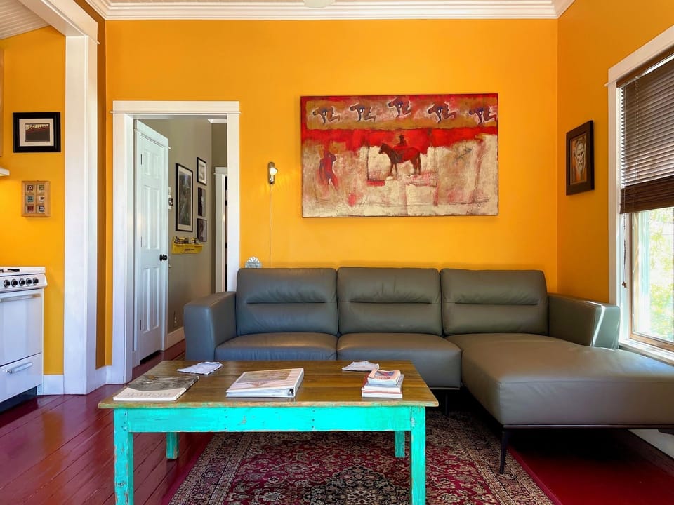 Living room with large leather couch to relax on & watch birds out the window.