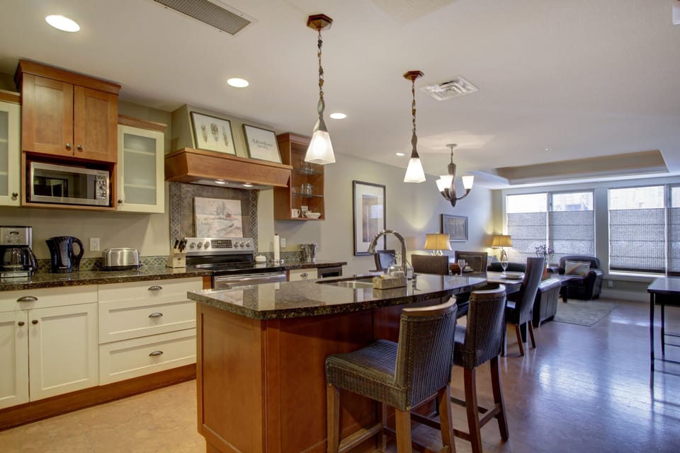 The gourmet, eat-in kitchen is fully stocked and features stainless steel appliances.