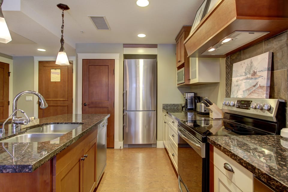 The gourmet, eat-in kitchen is fully stocked and features stainless steel appliances.