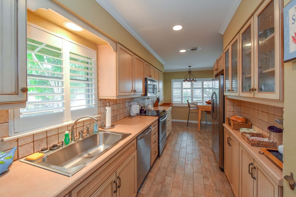 The kitchen is fully equipped and stocked with dishes, utensils, and cookware