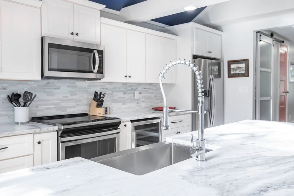This amazing kitchen boasts custom cabinets and modern appliances.