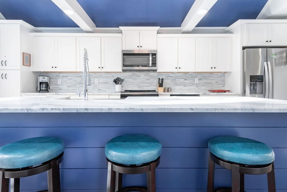 This amazing kitchen boasts custom cabinets and modern appliances.