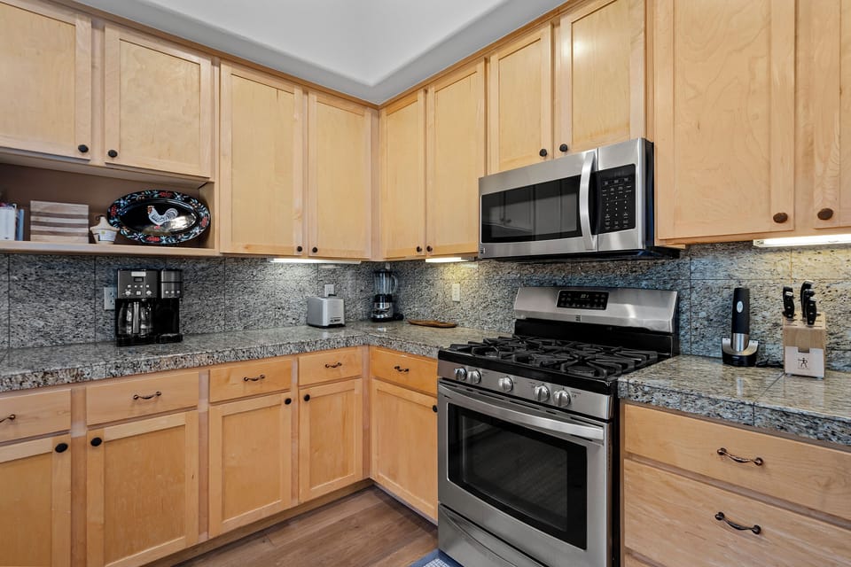 Your fully equipped kitchen features granite countertops, stainless steel appliances, and ample cabinet space—everything you need to prepare delicious home-cooked meals during your stay.