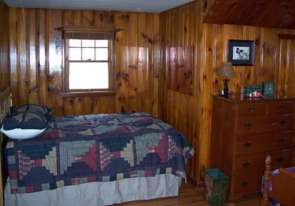 Rustic charm is the theme for this comfortably appointed bedroom.